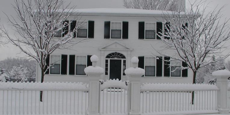 two-storey white house in snow
