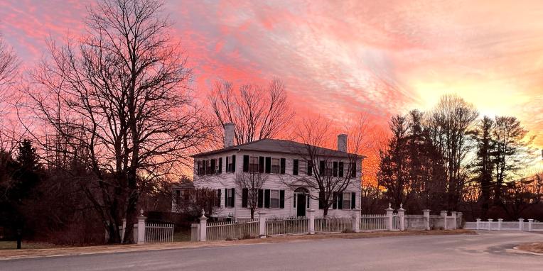 red sky behind a white house
