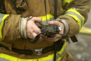Image of a firefighter holding a radio