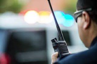 Image of a police officer using a radio